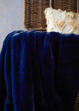 Orsina Luxurious Navy Fur Throw Draped Over a Decorative Chair for Cozy Home Decor
