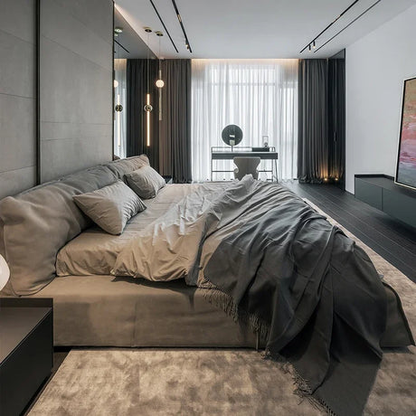 Modern bedroom featuring a Luxury Bed with elegant grey bedding and minimalist decor
