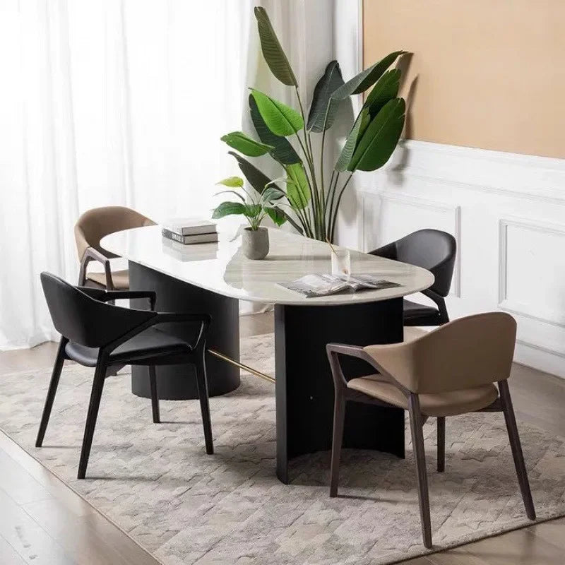 Elegant Nisu Home dining chairs arranged around a modern marble table with decorative plants
