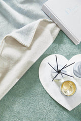 Soft Luxury Rug in muted tones with decorative items arranged for a stylish home aesthetic