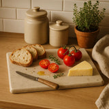 Orsina Serving Board with Fresh Vegetables, Cheese, Bread and Knife on a Kitchen Counter