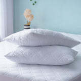 SHEET STORY Mattress Protector on a bed with two plush white pillows for added comfort