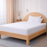 SHEET STORY Mattress Protector on a wooden bed for ultimate sleep protection and comfort