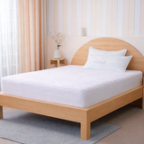 SHEET STORY Mattress Protector on a wooden bed for ultimate sleep protection and comfort