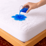SHEET STORY Mattress Protector showcasing water resistance with blue liquid spilled on a soft surface
