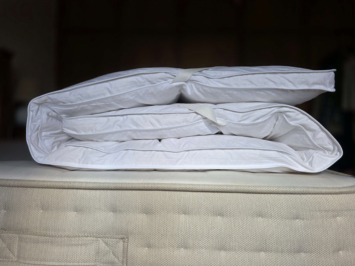 PillowPillow Mattress Topper folded neatly on a plush mattress for enhanced comfort and support