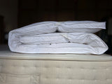 PillowPillow Mattress Topper folded neatly on a plush mattress for enhanced comfort and support