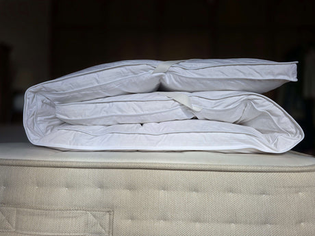 PillowPillow Mattress Topper folded neatly on a plush mattress for enhanced comfort and support