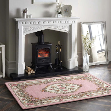 Elegant Medallion Rug in soft pink with floral design placed near a fireplace for a cosy atmosphere