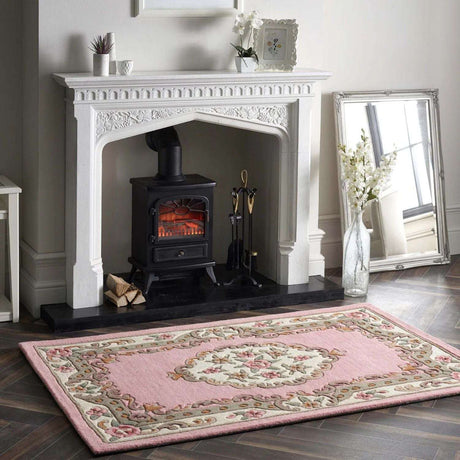 Elegant Medallion Rug in soft pink with floral design placed near a fireplace for a cosy atmosphere
