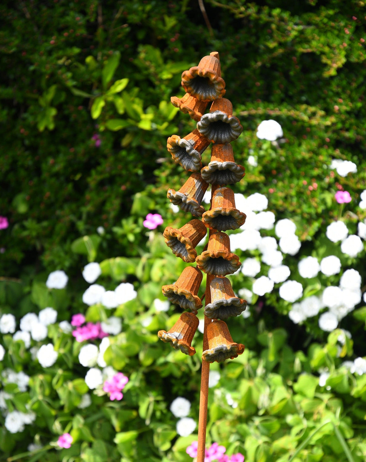 Ornamental Metal Flower Garden Stake with Multiple Bell-Shaped Flowers in a Colourful Garden