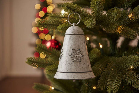 Beautiful metal hanging bell decorated with snowflakes, perfect for Christmas tree decorations