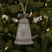 Shades 4 Seasons Metal Hanging Bell Christmas decoration featuring a rustic design on a Christmas tree