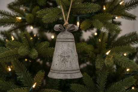 Shades 4 Seasons Metal Hanging Bell Christmas decoration featuring a rustic design on a Christmas tree