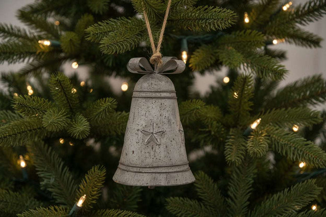Shades 4 Seasons Metal Hanging Bell Christmas decoration featuring a rustic design on a Christmas tree