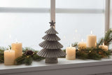 Metal Layered Tree Christmas decoration on a windowsill with candles and greenery