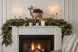Elegant Metal Reindeer Bowl atop a festive fireplace mantel with candles and holiday decorations