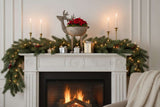 Elegant Metal Reindeer Bowl atop a festive fireplace mantel with candles and holiday decorations