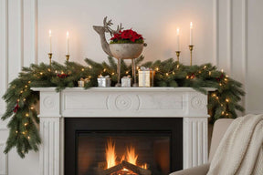 Elegant Metal Reindeer Bowl atop a festive fireplace mantel with candles and holiday decorations
