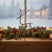Decorative Metal Reindeer on a window sill surrounded by holiday foliage and lanterns