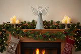 Metal Standing Angel decoration on a festive mantel with candles and Christmas garland