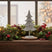 Metal Standing Tree Decoration on a Festive Mantle with Pinecones and Colourful Lights