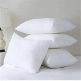 Four stacked white Microfibre Pillows on a bed with soft texture for a comfortable sleep