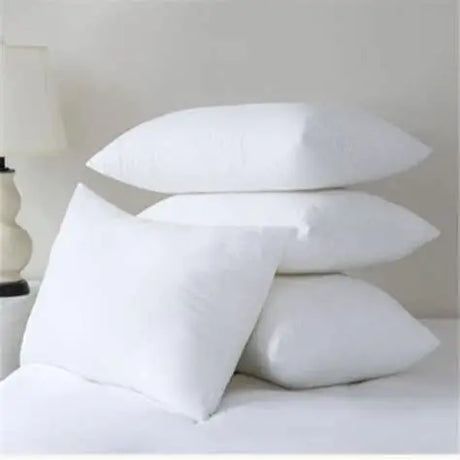 Four stacked white Microfibre Pillows on a bed with soft texture for a comfortable sleep