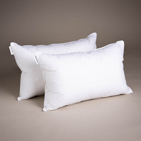 Two soft white Microfibre Pillows on a neutral background for comfortable sleeping