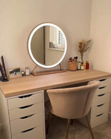 Stylish Hollywood mirror with warm lighting on a modern wooden desk for makeup or grooming