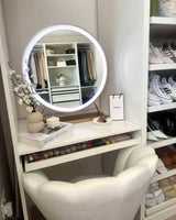 Stylish Hollywood mirror with LED lights above a chic vanity in a modern wardrobe space