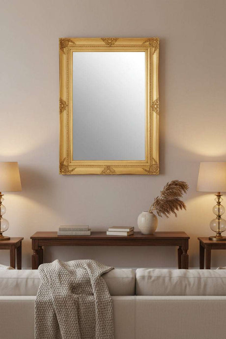 Orsina elegant gold-framed Wall Mirror above a sofa, enhancing living room decor