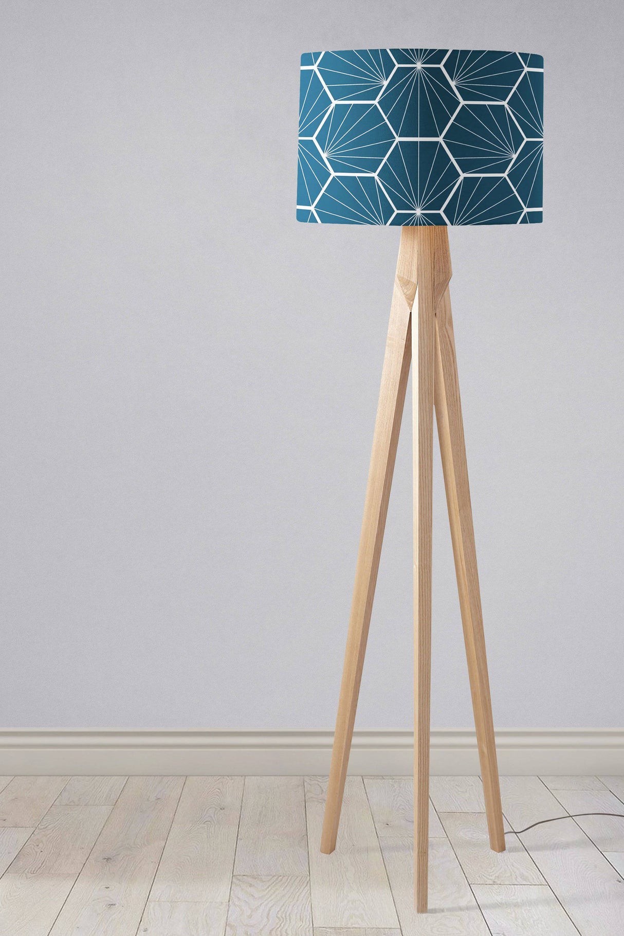 Shadow Bright geometric lampshade in teal design on a wooden tripod floor lamp