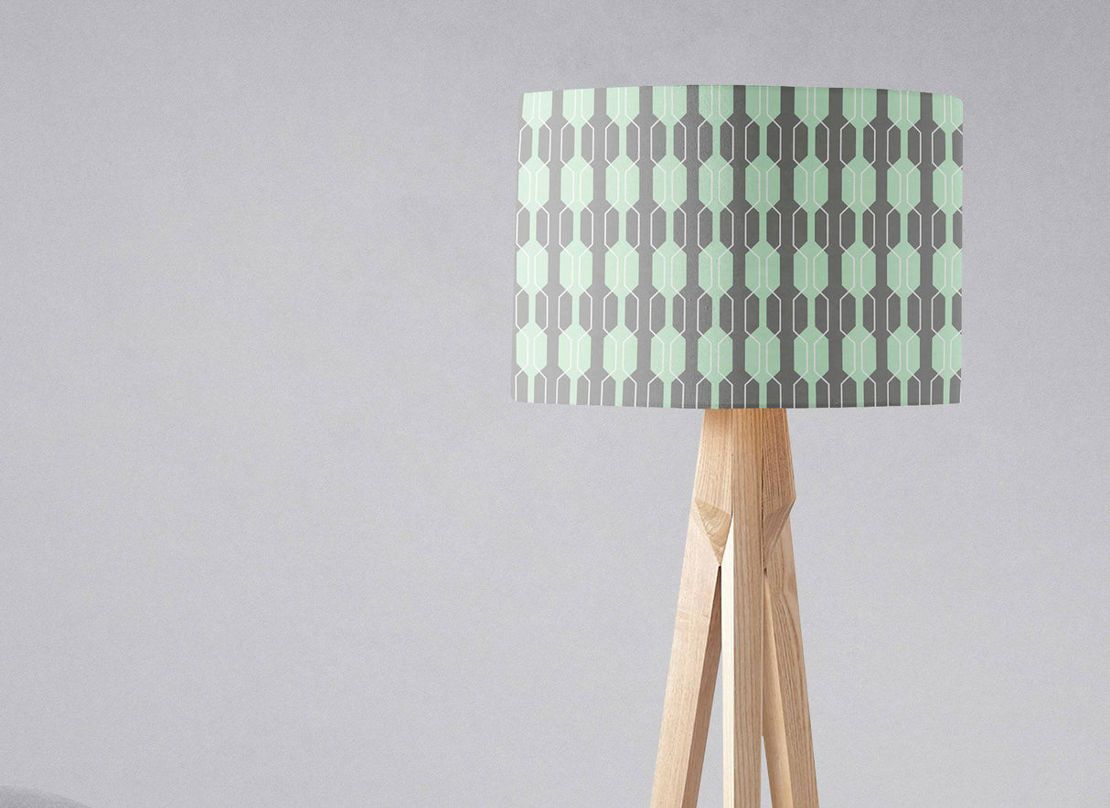 Shadow Bright Lampshade with a geometric mint and grey pattern on a wooden lamp base