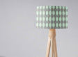 Geometric pattern lampshade by Shadow Bright on a wooden tripod lamp for stylish lighting