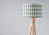 Geometric pattern lampshade by Shadow Bright on a wooden tripod lamp for stylish lighting