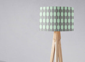 Geometric pattern lampshade by Shadow Bright on a wooden tripod lamp for stylish lighting