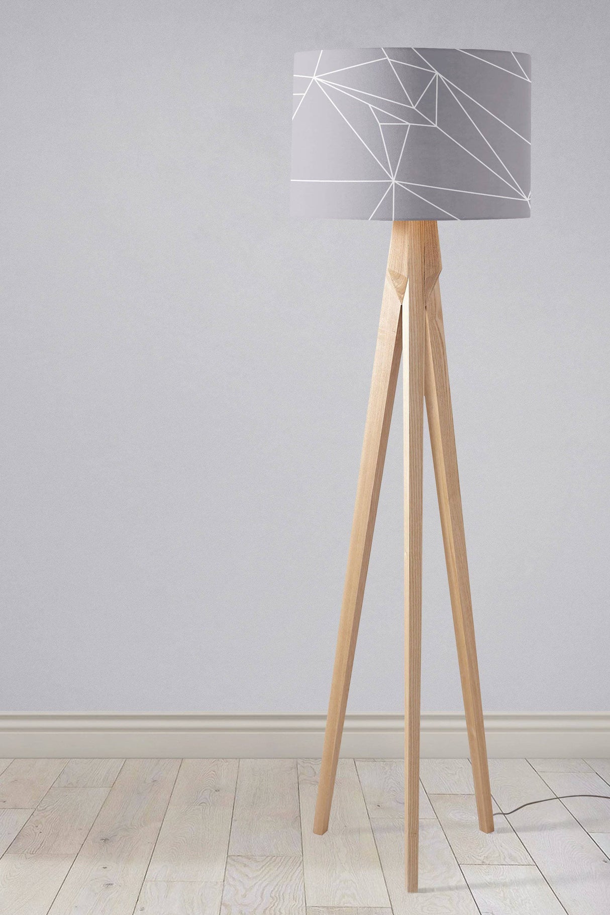 Contemporary lampshade by Shadow Bright with geometric pattern on a wooden tripod floor lamp