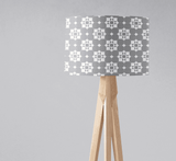 Stylish Shadow Bright lampshade with geometric grey pattern on a wooden tripod lamp