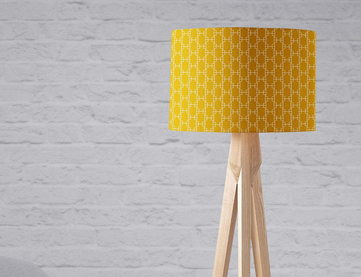 Stylish lampshade in yellow geometric pattern on a wooden tripod lamp for modern interiors