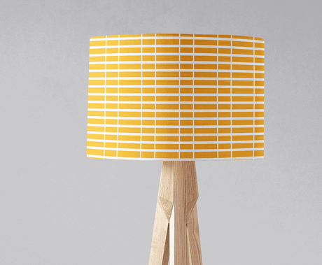 Yellow geometric lampshade by Shadow Bright on a wooden lamp base for modern decor