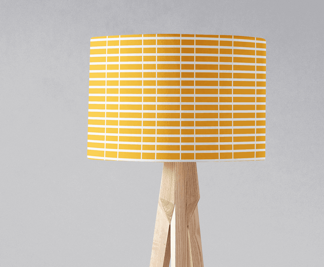 Yellow geometric lampshade by Shadow Bright on a wooden lamp base for modern decor