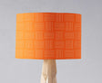 Bright orange lampshade with a geometric pattern designed by Shadow Bright for stylish lighting