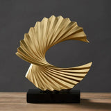 Stylish gold ornament in a swirling design, perfect for modern home decor