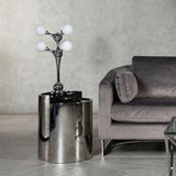 Orsina modern Table Lamp with four glass globes on stylish chrome base beside a grey sofa