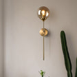 Stylish Light My House brass wall light with a globe shade, ideal for modern interiors