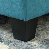 Close-up of a Modula Sofa leg with a dark wood finish against a soft rug