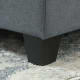 Close-up of a Wise Galleria Modular Sofa leg in black, showcasing a sleek design on a plush rug