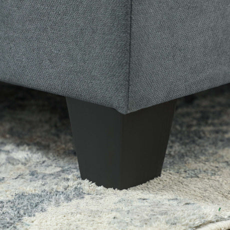 Close-up of a Wise Galleria Modular Sofa leg in black, showcasing a sleek design on a plush rug