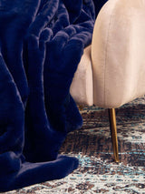 Orsina Luxurious Navy Fur Throw Draped Over a Soft Beige Sofa for a Cozy Decor Accent